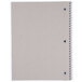 A close-up of a Universal spiral notebook with a white cover.