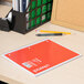 A Universal assorted color notebook on a desk with pencils.