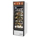 A True white refrigerated glass door wine merchandiser full of wine bottles.