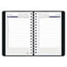 A spiral bound black Blueline daily planner with a calendar.