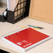A Universal 5 subject wirebound notebook with college ruled paper on a desk next to a pencil.