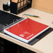 A Universal spiral bound 5 subject notebook on a desk.