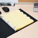 A yellow file folder with Avery Office Essentials 5-tab dividers inside.