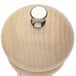 A close-up of a Chef Specialties Windsor natural maple pepper mill with a silver knob.