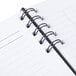 A white spiral-bound Rediform NotePro daily planner.