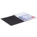 A spiral bound notebook with a black cover.