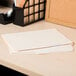 A group of Universal letter size file folders with assorted tabs on a wooden desk.