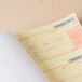 A Universal wirebound message book open to a carbonless page.