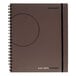 A gray spiral notebook with a circle on the cover.