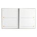 A close-up of a spiral bound At-A-Glance planning notebook with white pages.