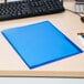 An Avery translucent blue folder on a wood desk.