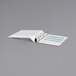 A white Universal Comfort Grip Deluxe Plus binder with blue stripes.