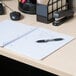 A Universal black wirebound notebook on a desk with a pen.