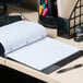 A black Universal 1 subject spiral notebook on a desk.