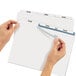 A pair of hands holding a piece of paper with Avery Index Maker dividers.