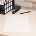 A white Universal legal size file folder with a black pen on top.