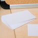 A stack of Universal white unruled index cards.