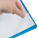 A hand holding a Universal Light Blue Leatherette Report Cover with a clear plastic sheet.