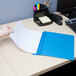 A person's hand using a Universal Office light blue leatherette report cover to hold a piece of paper.