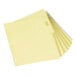 A stack of yellow file folders with white tabs.