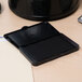 A black Avery Carter's pre-inked felt stamp pad on a desk.