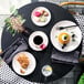 A table with Homer Laughlin china platters of food and drinks on it.