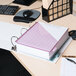 A white Universal economy view binder on a desk with a notebook and pen inside.