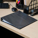 A black Universal deluxe non-stick view binder on a table.