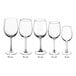A clear 16 oz. wine glass with a stem, shown among other wine glasses of various sizes.