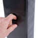 A person's hand holding a Universal black economy view binder