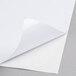 A close-up of a white paper with a curled corner.