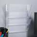 A Universal clear plastic wall hanging file holder with 3 pockets.