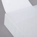 A white Universal Deluxe View Binder with paper on the cover.
