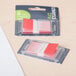 A plastic container with red and white Universal red page flags.