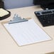 A brown Universal clipboard on a black surface.