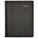 A black notebook with a gold logo on it.