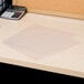 A desk with a calculator and Avery sheet protectors holding papers.