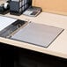 A binder with Avery semi-clear sheet protectors on a desk.