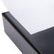 A close-up of a black Universal economy non-stick view binder with a white sheet of paper inside.