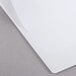 A white Universal Deluxe Non-Stick View Binder with a white paper on a gray surface.