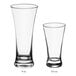 Acopa flared pilsner beer tasting glasses in two sizes on a white background.