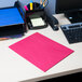 A red Universal letter size paper folder on a desk with a blue sheet of paper inside.