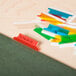 A group of colorful plastic tabs on a table.