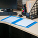 A light blue Universal Deluxe Non-Stick View Binder on a desk with a computer and a keyboard.