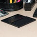 A black rectangular Avery felt stamp pad on a desk.