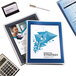 A navy blue 6-pocket Avery Flexi-View organizer with a group of papers and a calculator inside.