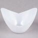 A white Fineline Tiny Tureens bowl on a gray surface.