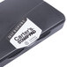 An Avery Carter's black pre-inked stamp pad on a counter.