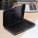 A black Avery Carter's pre-inked stamp pad on a desk.