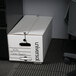 A white Universal economy fiberboard storage box with black text on it.